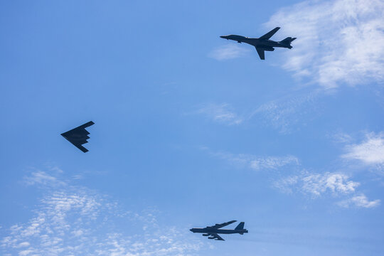 Jersey City, New Jersey, United States - 04 July 2026: View of a B-2 Spirit, B-1 Lancer, and B-52 Stratofortress flying in formation over Liberty State Park.