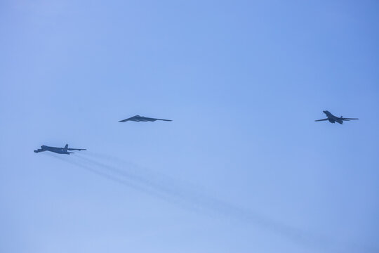 Jersey City, New Jersey, United States - 04 July 2026: View of military aircraft including a B-2 Spirit stealth bomber and other jets flying in formation against a clear blue sky during a flyover.