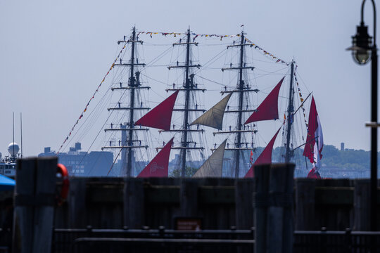 Jersey City, New Jersey, United States - 04 July 2026: View of the BAP Union tall ship with red sails and sailors on the rigging at Liberty State Park.