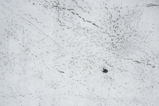 Karaman Merkez, Karaman, Turkiye - 01 January 2026: Aerial view of Aktekke Meydani covered in fresh snow with numerous footprints and a lone person walking across the square.