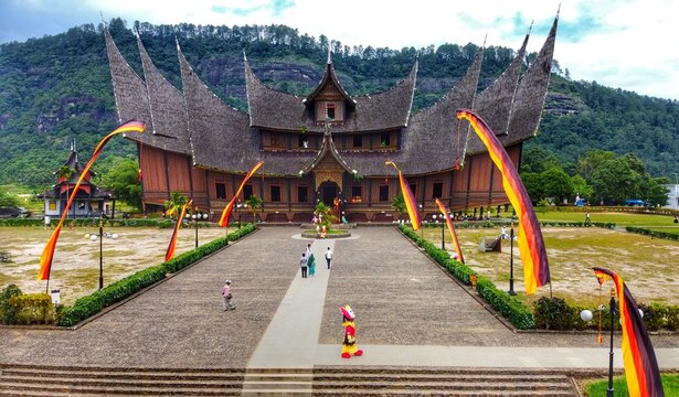 Kecamatan Tanjung Emas, Indonesia - 08 January 2020: Aerial view of Istano Basa Pagaruyung, a traditional Minangkabau palace with curved roofs, surrounded by hills and a courtyard.