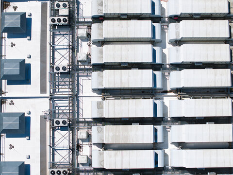 Aerial view of ATOS data center rooftop with rows of industrial cooling units and ventilation systems in Birmingham, England, United Kingdom.