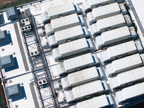 Aerial view of the ATOS Digital transformation data center roof featuring rows of industrial HVAC ventilation units and cooling systems in Birmingham, England, United Kingdom.