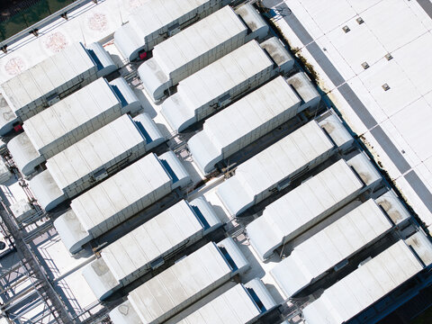 Aerial view of the ATOS data center roof featuring rows of industrial HVAC ventilation units and cooling systems in Birmingham, England, United Kingdom.