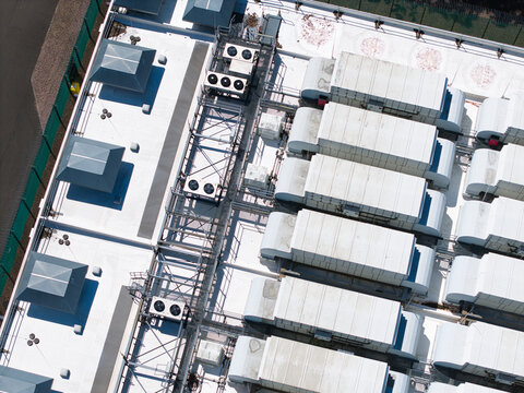 Aerial view of ATOS data center rooftop featuring rows of industrial cooling units and ventilation systems in Birmingham, England, United Kingdom.