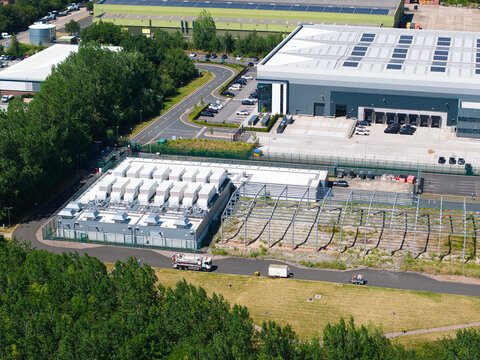 Aerial view of the ATOS digital transformation data center featuring industrial buildings, cooling units, and surrounding infrastructure in Birmingham, England, United Kingdom.