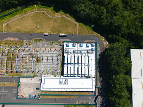 Aerial view of the ATOS data center facility featuring white rooftops, HVAC cooling units, and surrounding green space in Birmingham, England, United Kingdom.
