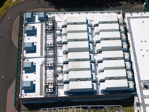 Aerial view of the ATOS Digital transformation data center rooftop featuring rows of industrial HVAC cooling units and ventilation systems in Birmingham, England, United Kingdom.