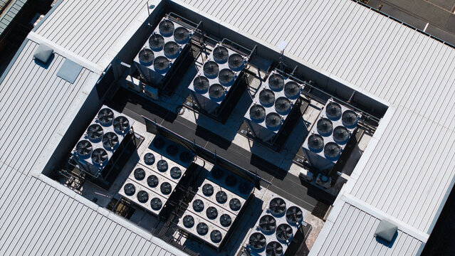 Aerial view of the Six Degrees Data Centre roof featuring multiple large HVAC cooling units and ventilation fans for AI automation infrastructure in Studley, England, United Kingdom.