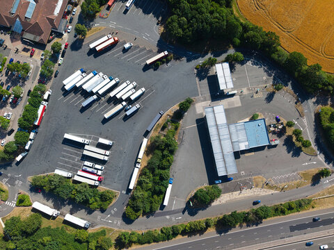 Aerial view of Welcome Break Warwick Southbound Services M40 with rows of parked trucks and service station facilities located near the motorway in Warwick, England, United Kingdom.