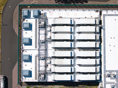 Aerial view of ATOS Digital transformation data center featuring rows of industrial cooling units and technical infrastructure on a flat rooftop in Birmingham, England, United Kingdom.