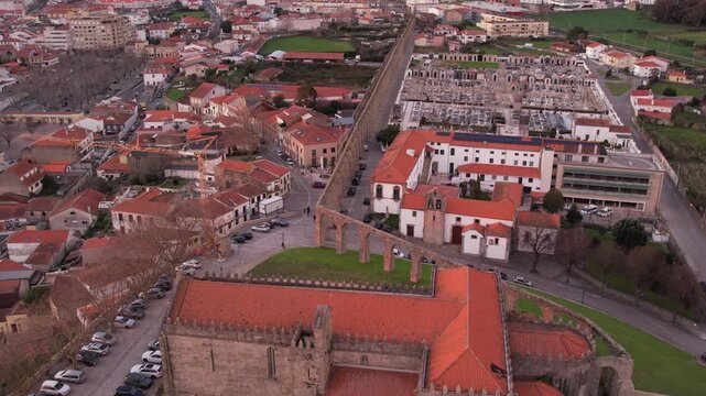 Aerial view of the historic Igreja e Mosteiro de Santa Clara with its stone architecture and red-tiled roofs in the urban landscape of Vila do Conde, Porto, Portugal.