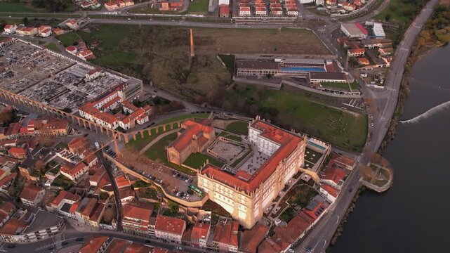 Aerial view of the historic Igreja e Mosteiro de Santa Clara with its red-tiled roofs, courtyard, and adjacent aqueduct in the town of Vila do Conde, Porto, Portugal.
