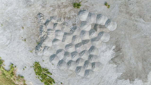 Aerial view of gravel piles arranged in a grid pattern on a construction site in Sremska Mitrovica, Vojvodina, Serbia.
