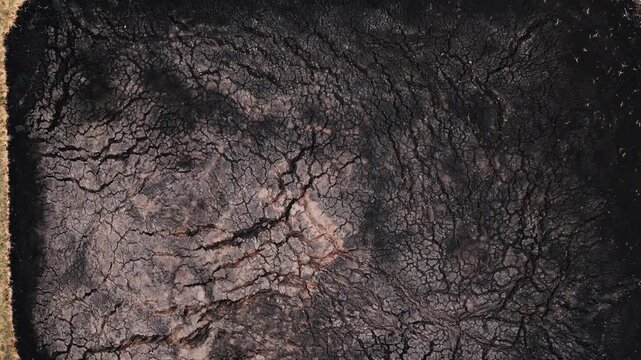 Aerial view of dry cracked earth with intricate patterns and parched soil texture in Serbia.