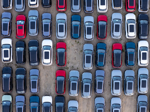 Aerial view of many colorful cars parked in rows at a large outdoor lot in Gdansk, Pomeranian Voivodeship, Poland.