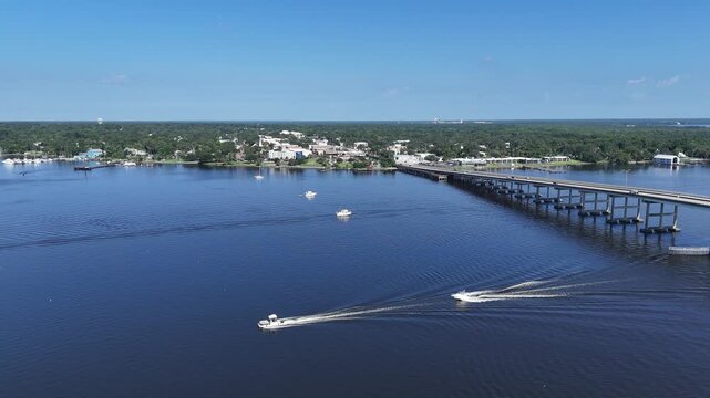 Boats near the Memorial Bridge on the St Johns River with historic downtown Palatka in the background in Putnam County, Florida. 