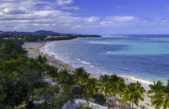 Aerial view of Playa Dorada with palm trees, turquoise water, and sandy beach in Puerto Plata, Puerto Plata Province, Dominican Republic.