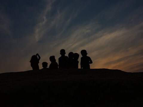 Cox's Bazar, Chittagong Division, Bangladesh - 17 July 2026: View of children silhouetted against a dramatic sunset at the Rohingya refugee camp.