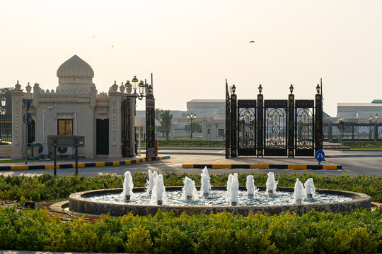 View of the ornate entrance gate and a circular fountain at the University of Sharjah, featuring traditional Islamic architectural details in Sharjah, Sharjah, United Arab Emirates.