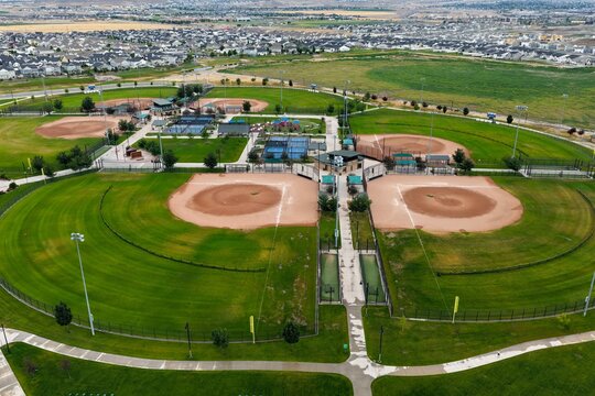 Aerial view of the sports complex featuring multiple baseball fields, green spaces, and surrounding modern residential housing in Saratoga Springs, Utah, United States.
