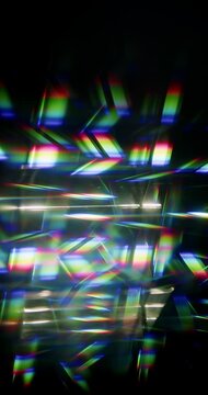 Light ray shining through a prism for angled beams of sparkling shine in brilliant colors. Swirling reflective glass with beaming lights creating visual effect of a brilliant dazzling rainbow.