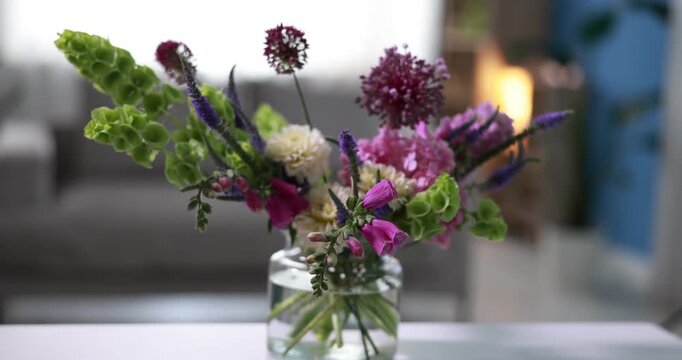 Bouquet of beautiful summer flowers in vase on white table indoors, closeup