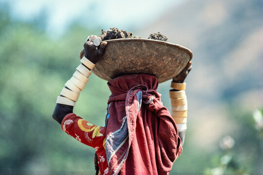 Southern India - March 1986: View of a Banjara woman carrying a heavy load