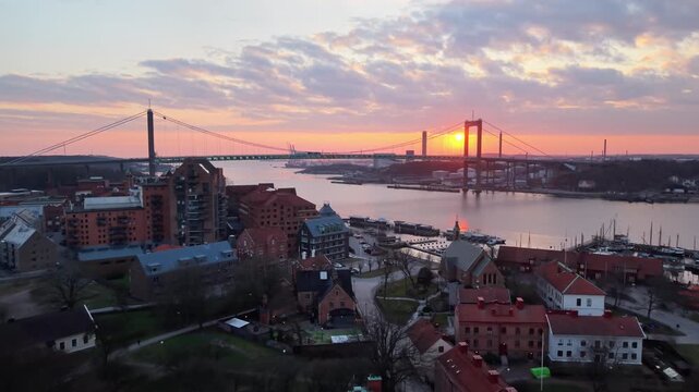 Aerial view of Klippan and the Alvsborgsbron bridge at sunset, featuring historic buildings and the Gota alv river in the city of Goteborg, Vastra Gotalands lan, Sweden.