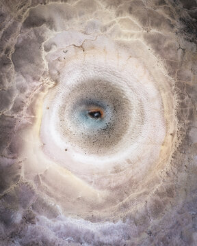 Aerial view of Hveravellir geothermal pool with vibrant mineral deposits and steaming water in Hunabyggd, Iceland.