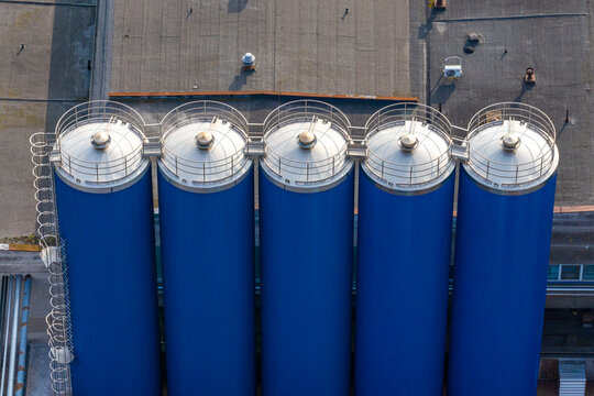 Aerial view of raw milk storage and cooling tanks on a flat industrial roof in Suwalki, Podlaskie, Poland.