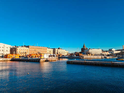 Helsinki, Finland - 31 December 2025: View of the Helsinki Market Square with the Uspenski Cathedral in the background under a clear blue sky.