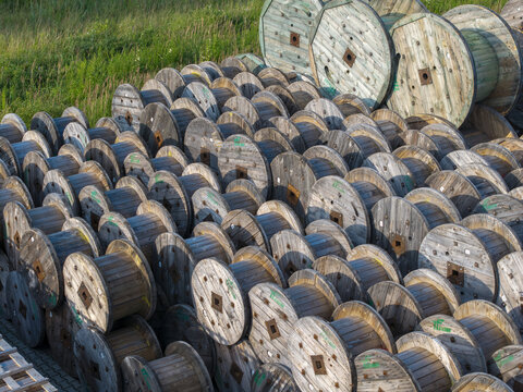 Krakow, Poland - 18 July 2026: Aerial view of Tele-Fonika Kable industrial site featuring numerous wooden cable reels stacked in an outdoor storage yard.