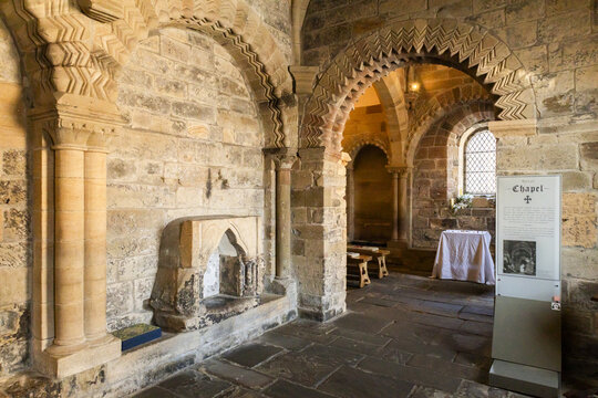 View of the historic Norman chapel interior with intricate chevron-patterned stone arches and weathered masonry walls at Newcastle Castle Keep, Newcastle upon Tyne, England, United Kingdom.