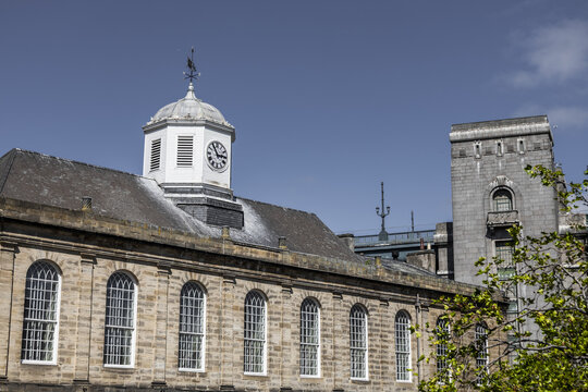 View of the historic Guildhall with its distinctive clock tower and arched windows under a clear blue sky in Newcastle upon Tyne, England, United Kingdom.