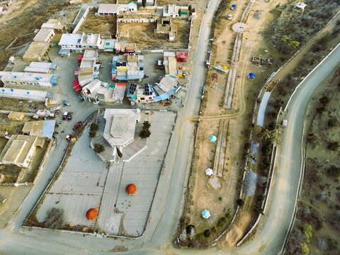 Aerial view of Fort Munro Bazar showing the central square, surrounding shops, and winding roads in Dera Ghazi Khan, Punjab, Pakistan.