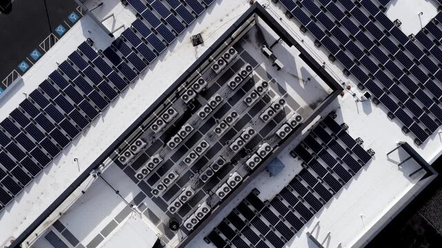 Aerial view of solar panels and HVAC units on an office building rooftop in Lehi, Utah, United States.