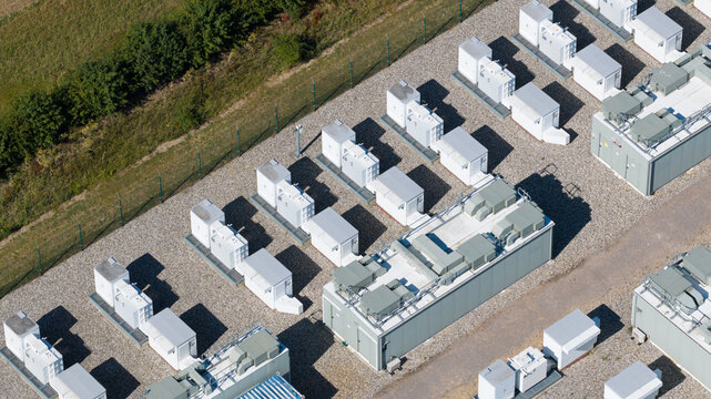 Aerial view of Pelham Storage Limited featuring rows of white battery energy storage containers on a gravel site in Bishop's Stortford, England, United Kingdom.