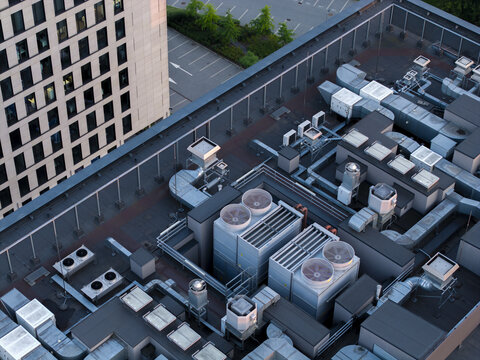 Aerial view of an AI data center cooling system with industrial fans and ventilation units on a rooftop in Krakow, Lesser Poland Voivode, Poland.