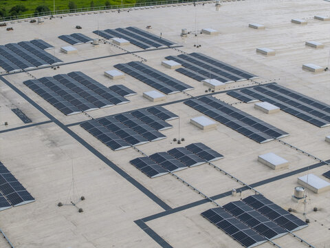 Aerial view of a logistics hub roof featuring extensive solar panel arrays, ventilation units, and lightning protection systems in Skawina, Lesser Poland Voivode, Poland.