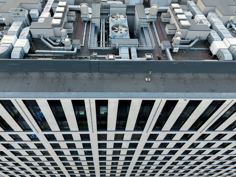 Aerial view of the AI data center cooling system on the rooftop of a modern office building with ventilation ducts and fans in Krakow, Lesser Poland Voivode, Poland.