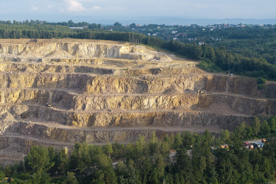 Aerial view of the Porphyry and Diabase Mine featuring terraced rock excavations and surrounding forest in Krakow, Lesser Poland Voivodeship, Poland.