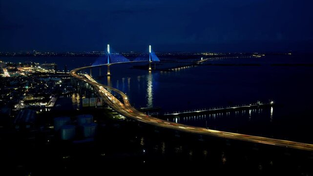 Aerial view of the illuminated Cebu-Cordova Link Expressway at night with traffic flowing over the water in Cebu City, Central Visayas, Philippines.