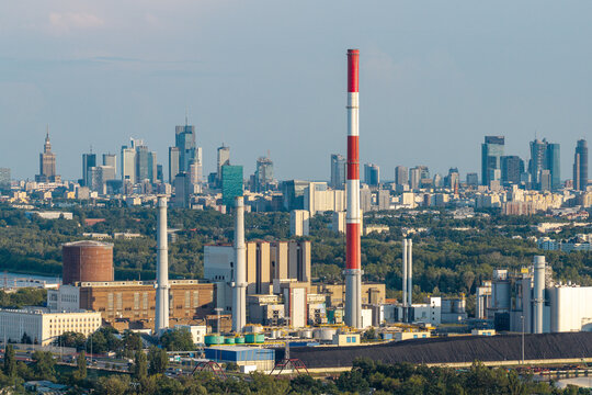 Warszawa, Poland - 14 July 2026: Aerial view of EC Zeran power plant with its prominent red and white chimney, industrial infrastructure, and the Warsaw skyline in the background.