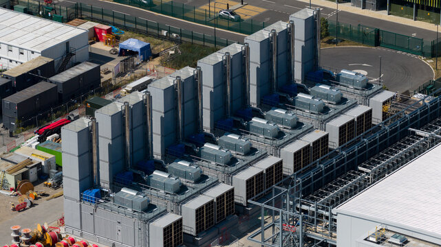 Aerial view of the Kao Data facility featuring large industrial cooling units and HVAC systems on the roof in Harlow, England, United Kingdom.