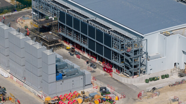 Aerial view of the Kao Data facility featuring industrial infrastructure, cooling units, and ongoing construction work in Harlow, England, United Kingdom.