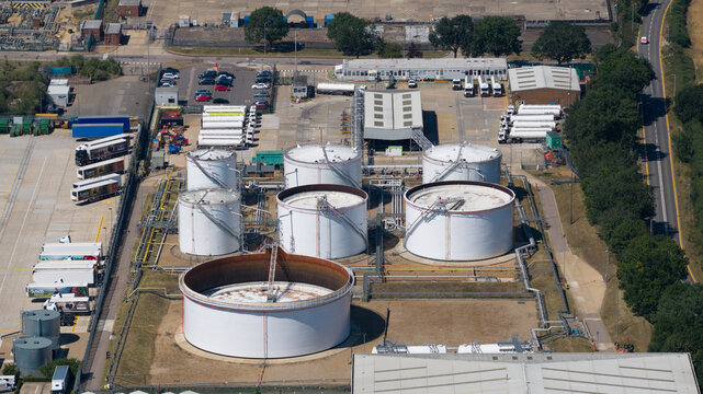 Hemel Hempstead, United Kingdom - 11 July 2026: Aerial view of Buncefield Terminal with large white industrial storage tanks, pipelines, and parked tanker trucks.