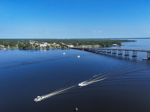 Boats near the Memorial Bridge on the St Johns River with historic downtown Palatka in the background in Putnam County, Florida. 