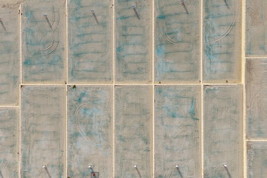Aerial view of a residential development site with cleared land plots, boundary lines, and tire tracks in Perth, Western Australia, Australia.