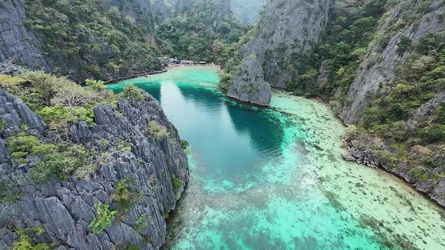 FPV aerial view of Kayangan Lake with turquoise water and limestone cliffs in Coron, Mimaropa, Philippines.